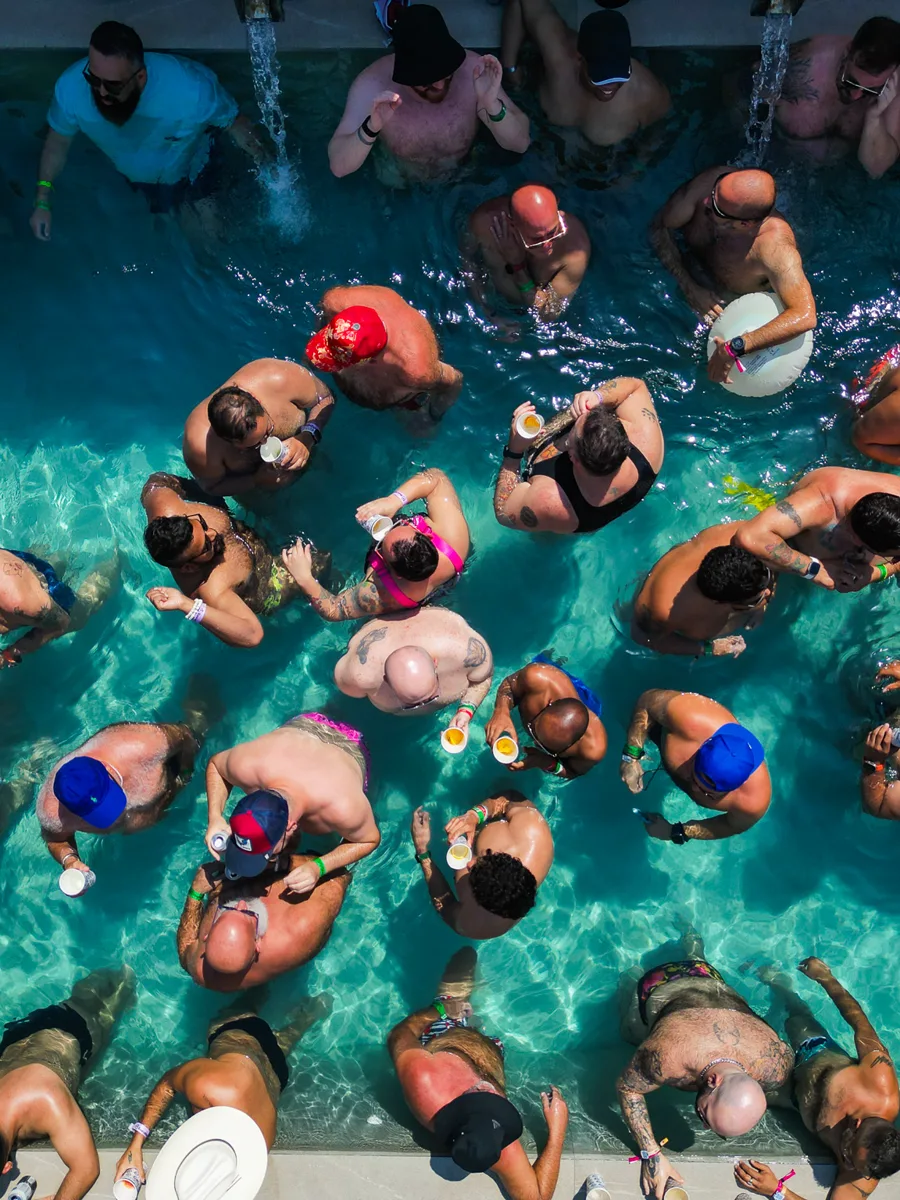 Aerial view of a packed Bearadise pool party in Puerto Vallarta