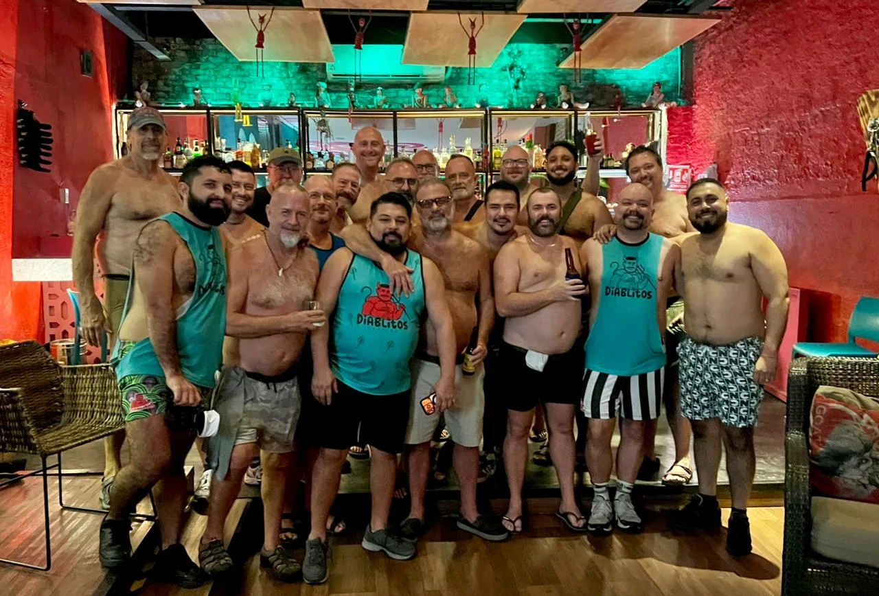 The Tummy Tuesday crowd at the bar at Diablitos Cantina, several in Diablitos tank tops